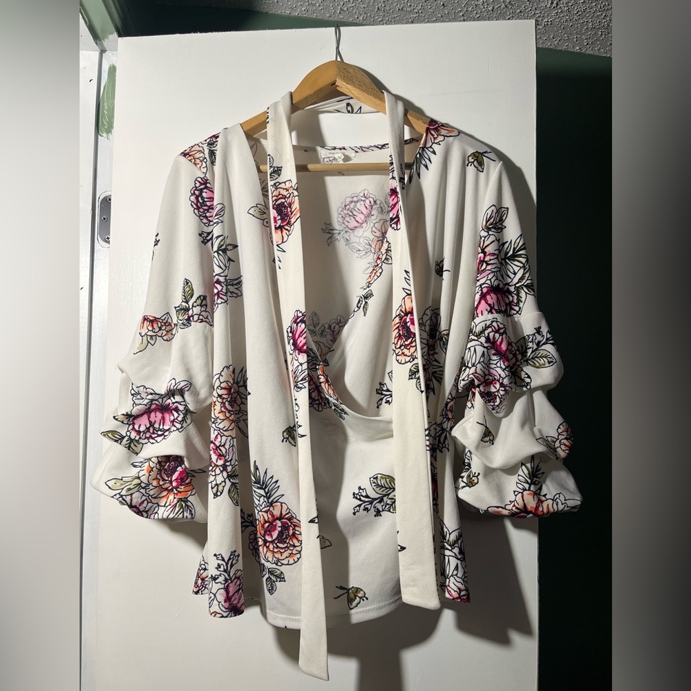 Floral mock wrap blouse with exaggerated sleeves